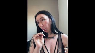 Busty british babe teases you while swallowing a lollipop